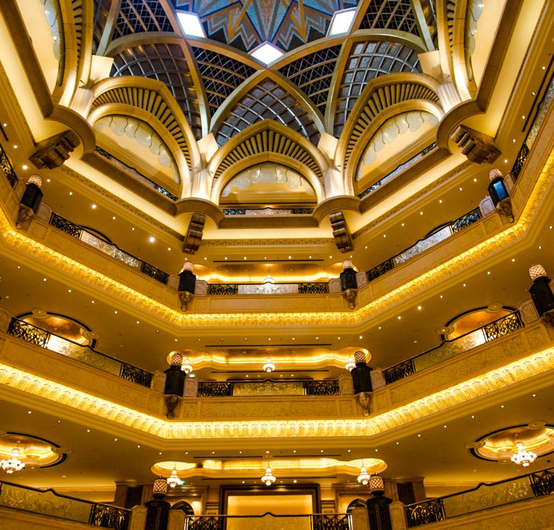 A woman standing in a large room with chandeliers